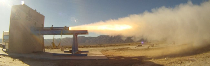 Large solid rocket motor blasting away on a rocket test stand